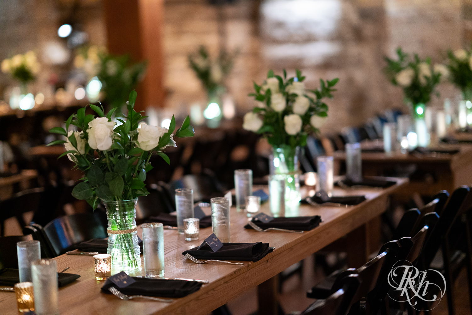 Indoor reception setup with candles and flowers in Hall of Kings in Minneapolis, Minnesota.