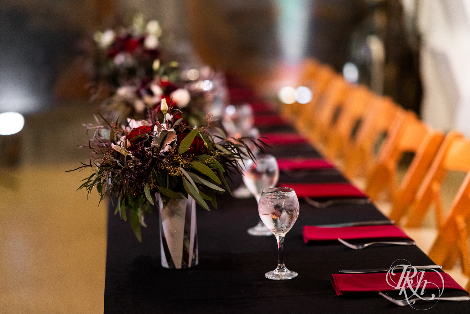Wedding reception head table with black and red setup at Warehouse Winery in Saint Louis Park, Minnesota.