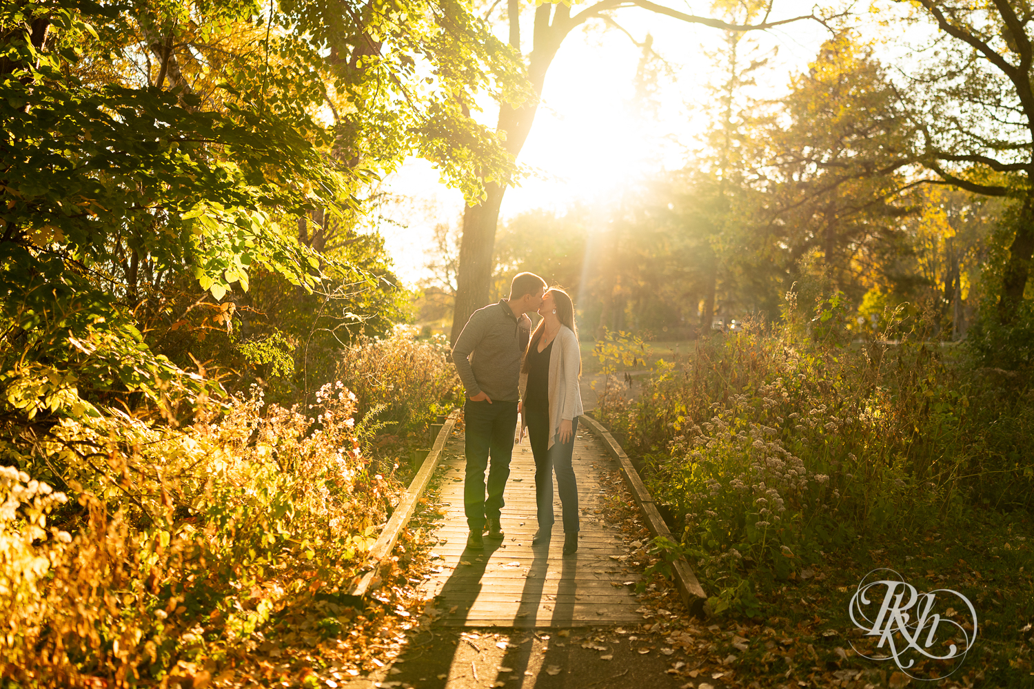 Man and woman kissing during sunset at Matoska Park in White Bear Lake, Minnesota. 