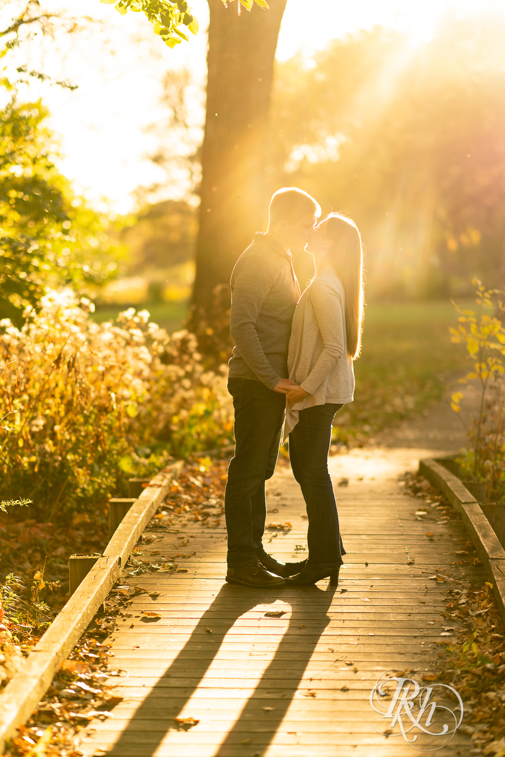 Man and woman kissing during sunset at Matoska Park in White Bear Lake, Minnesota. 