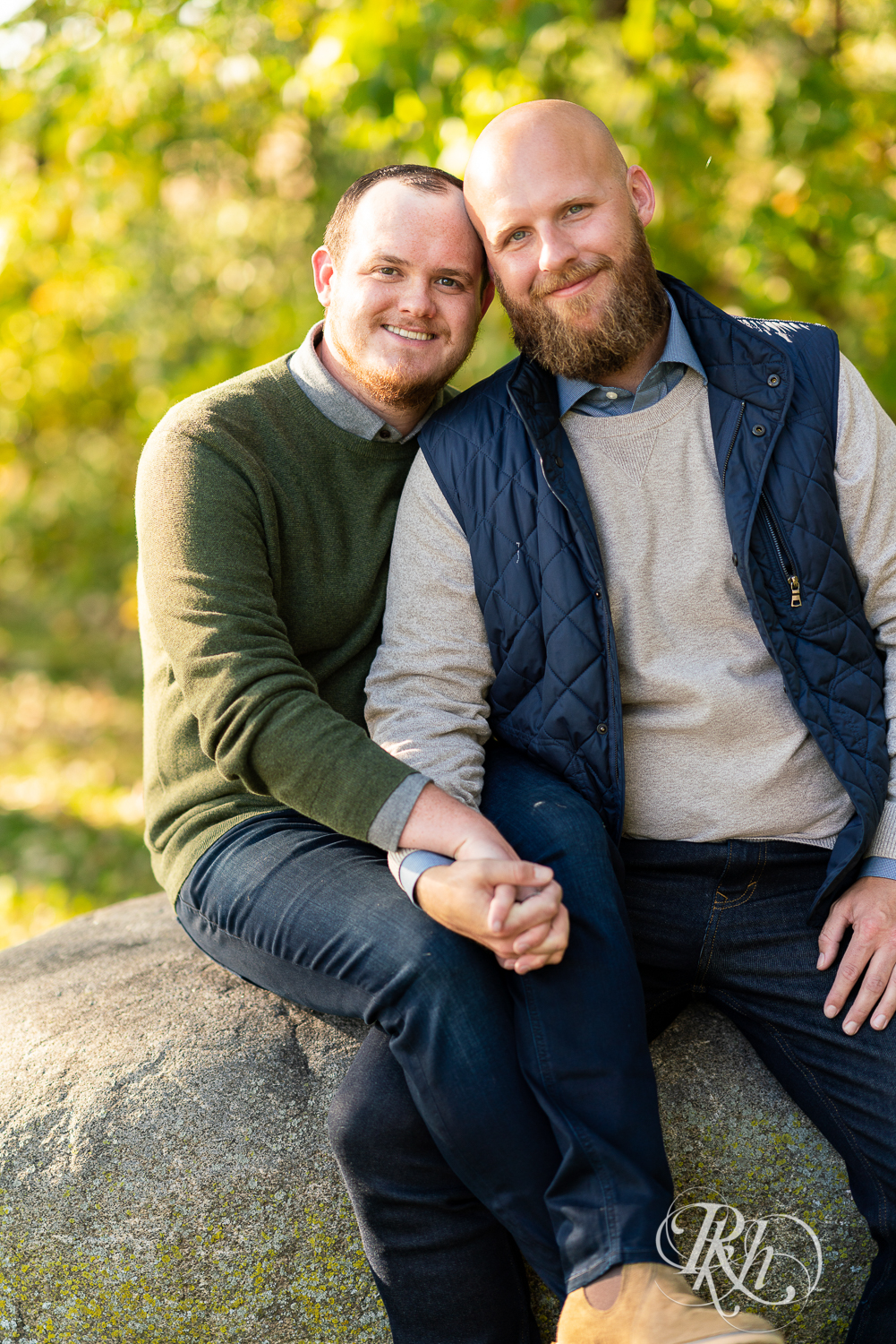 Two gay men holding hands and smiling in Belle Plaine, Minnesota.