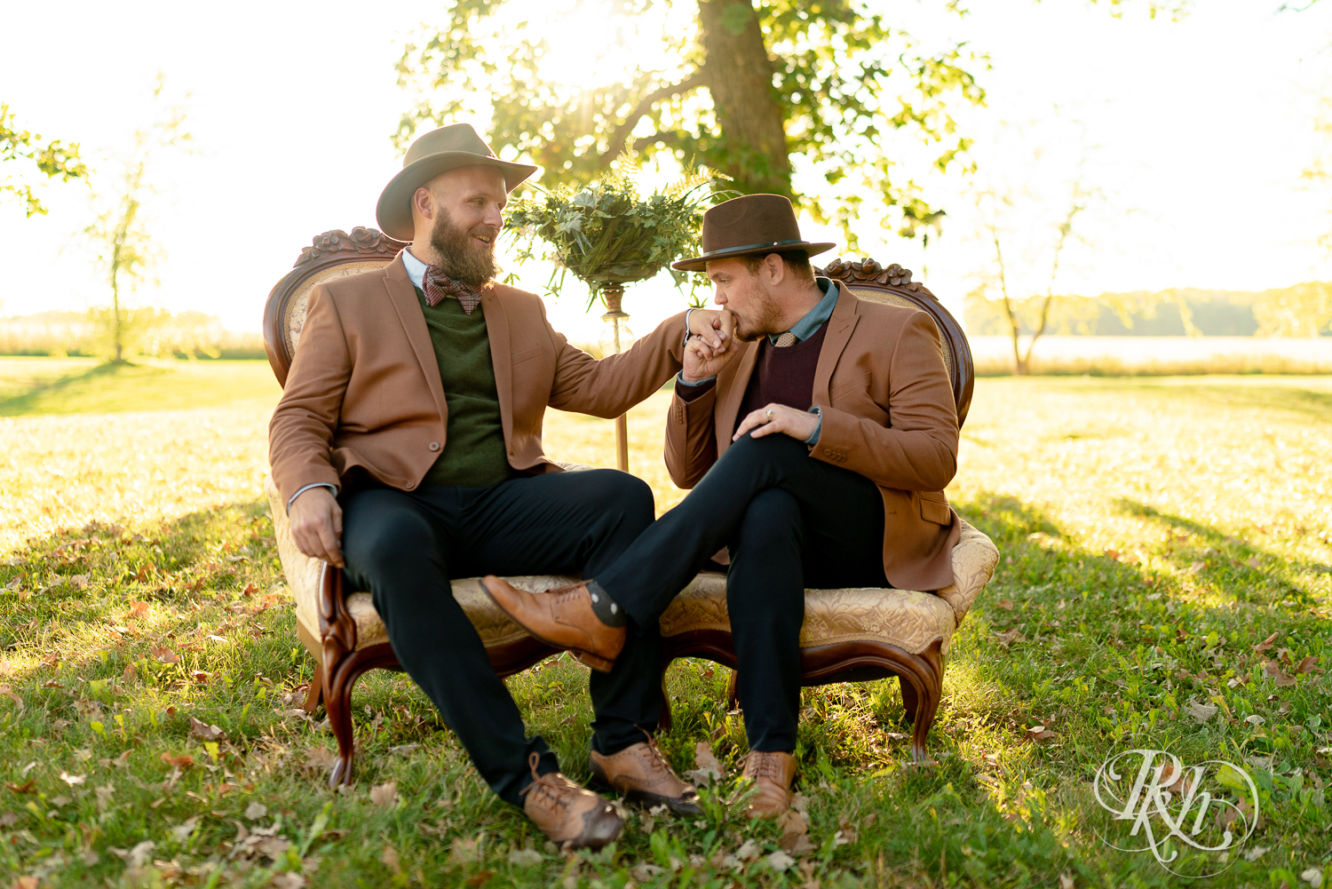 Two gay men kissing in suits and hats in Belle Plaine, Minnesota.
