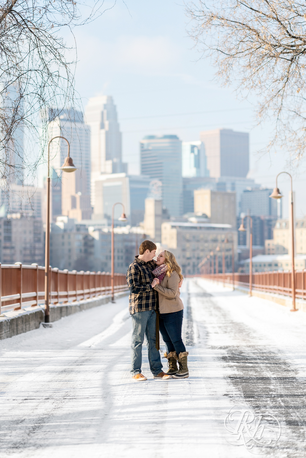 Man and woman standing on the Stone Arch Bridge in Minneapolis, Minnesota.