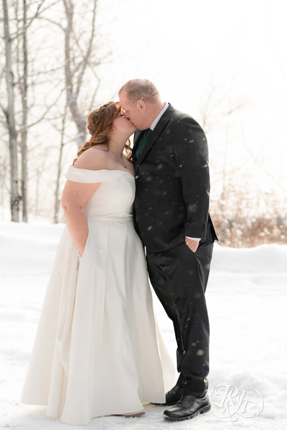 Bride and groom kissing in the snow at Grand Superior Lodge in Two Harbors, Minnesota.