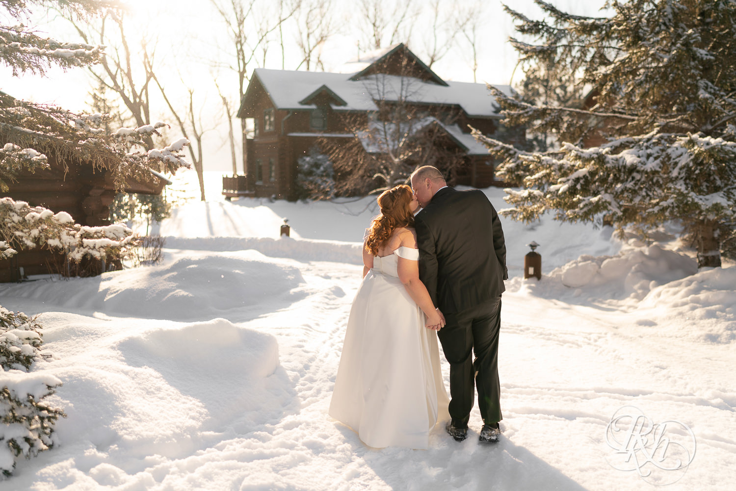 Bride and groom kissing in the snow at Grand Superior Lodge in Two Harbors, Minnesota.