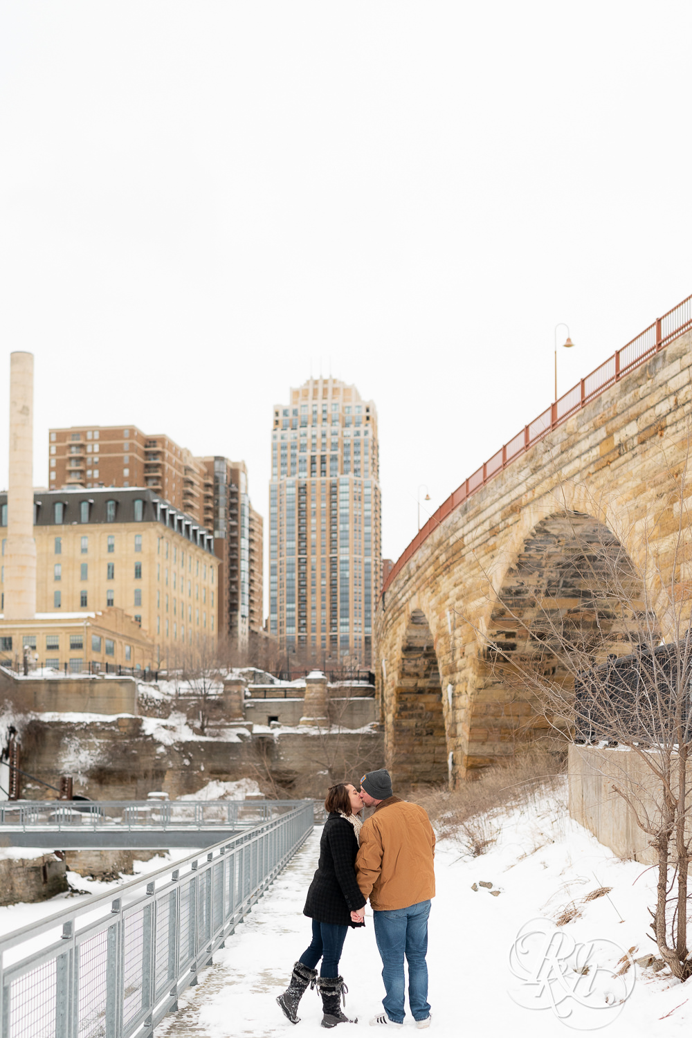Man and woman walking in snow at Mill City Ruins in Minneapolis, Minnesota.
