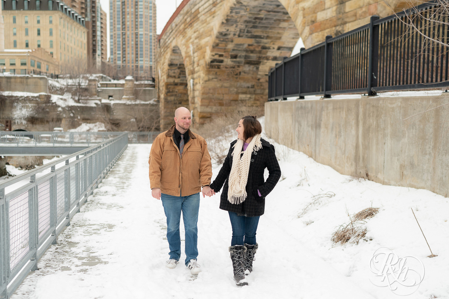 Man and woman walking in snow at Mill City Ruins in Minneapolis, Minnesota.