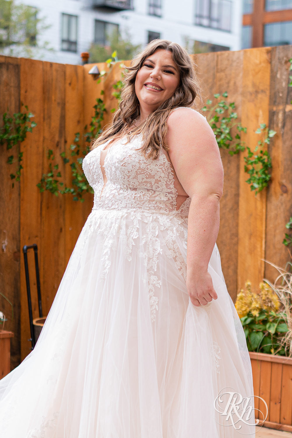 Plus size bride dancing in wedding dress in Minneapolis, Minnesota.