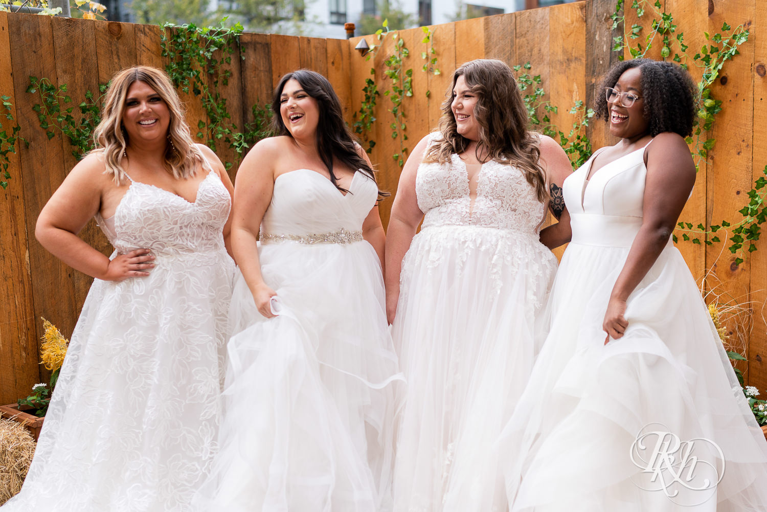 Plus size brides dancing in wedding dresses in Minneapolis, Minnesota.