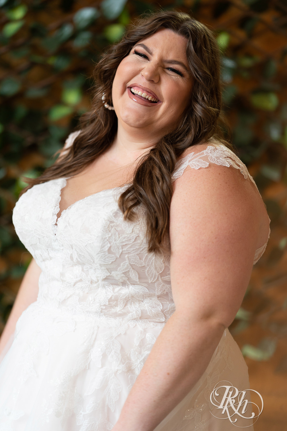 Plus size bride looking over shoulder in wedding dresses in Minneapolis, Minnesota.