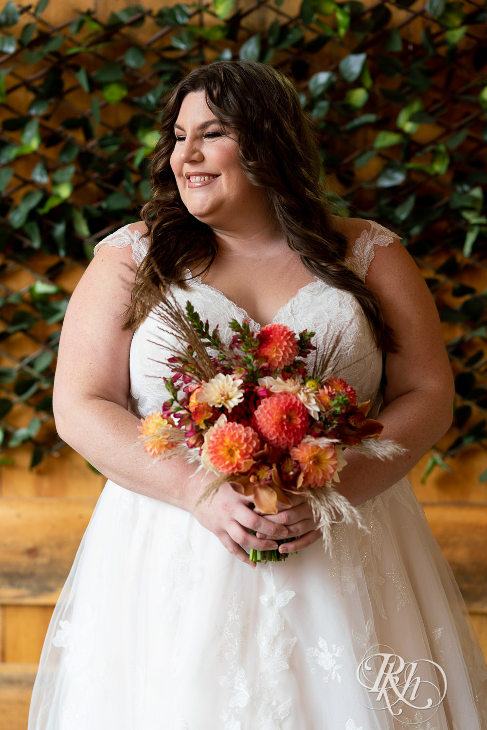 Plus size bride holding flowers in wedding dresses in Minneapolis, Minnesota.