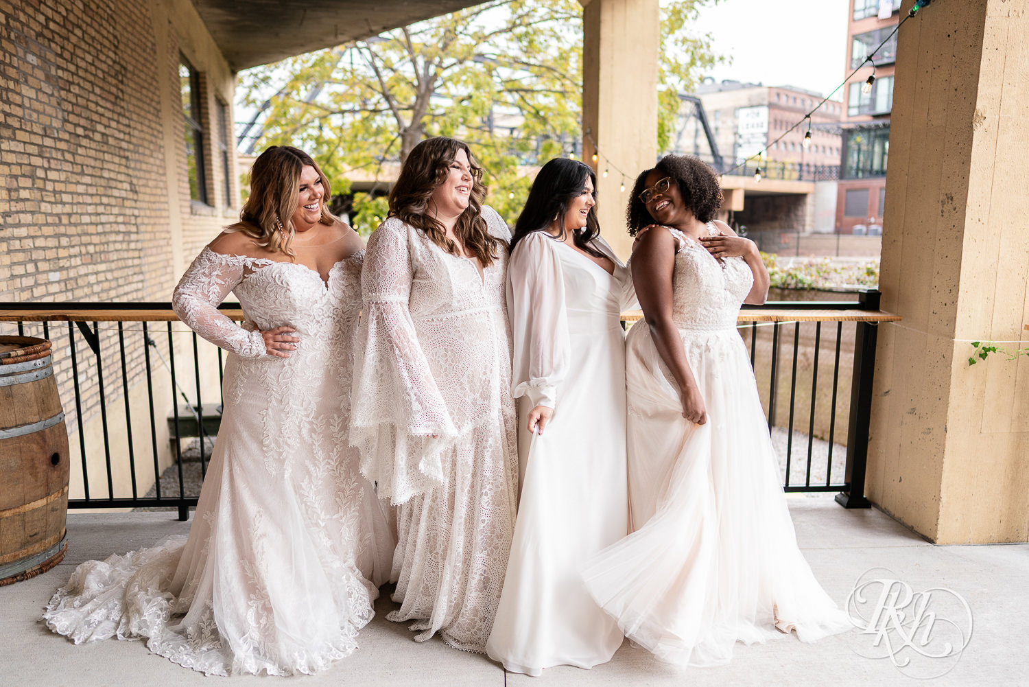 Plus size brides smiling and laughing in wedding dresses in Minneapolis, Minnesota.