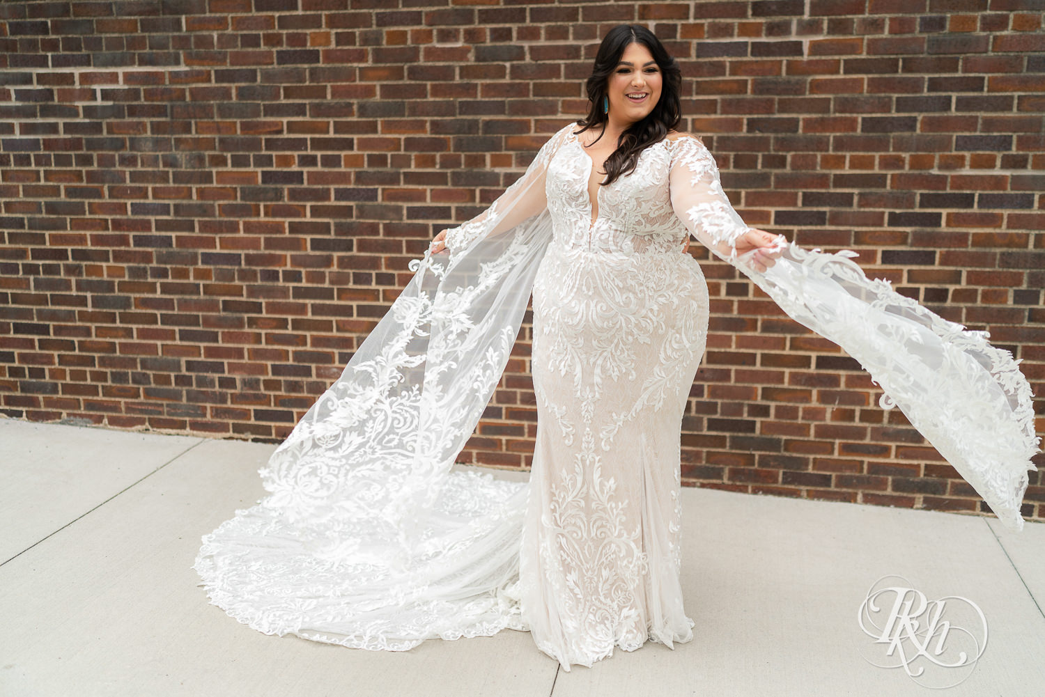 Plus size bride smiling and twirling wedding dress in Minneapolis, Minnesota.