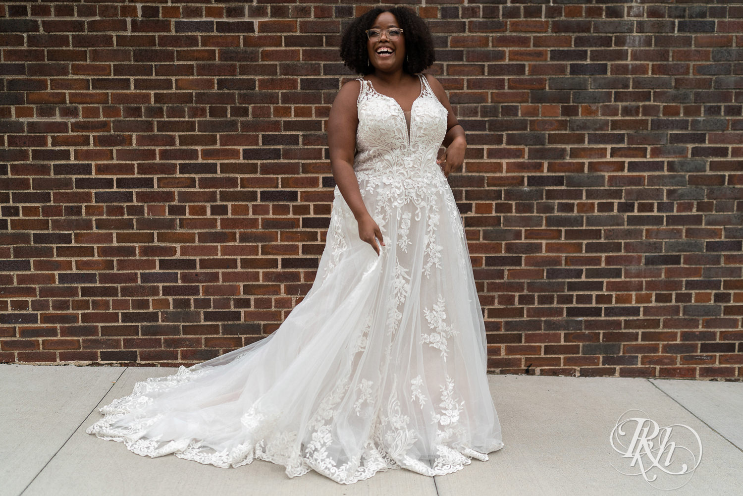 Black plus size bride smiling in wedding dress in Minneapolis, Minnesota.