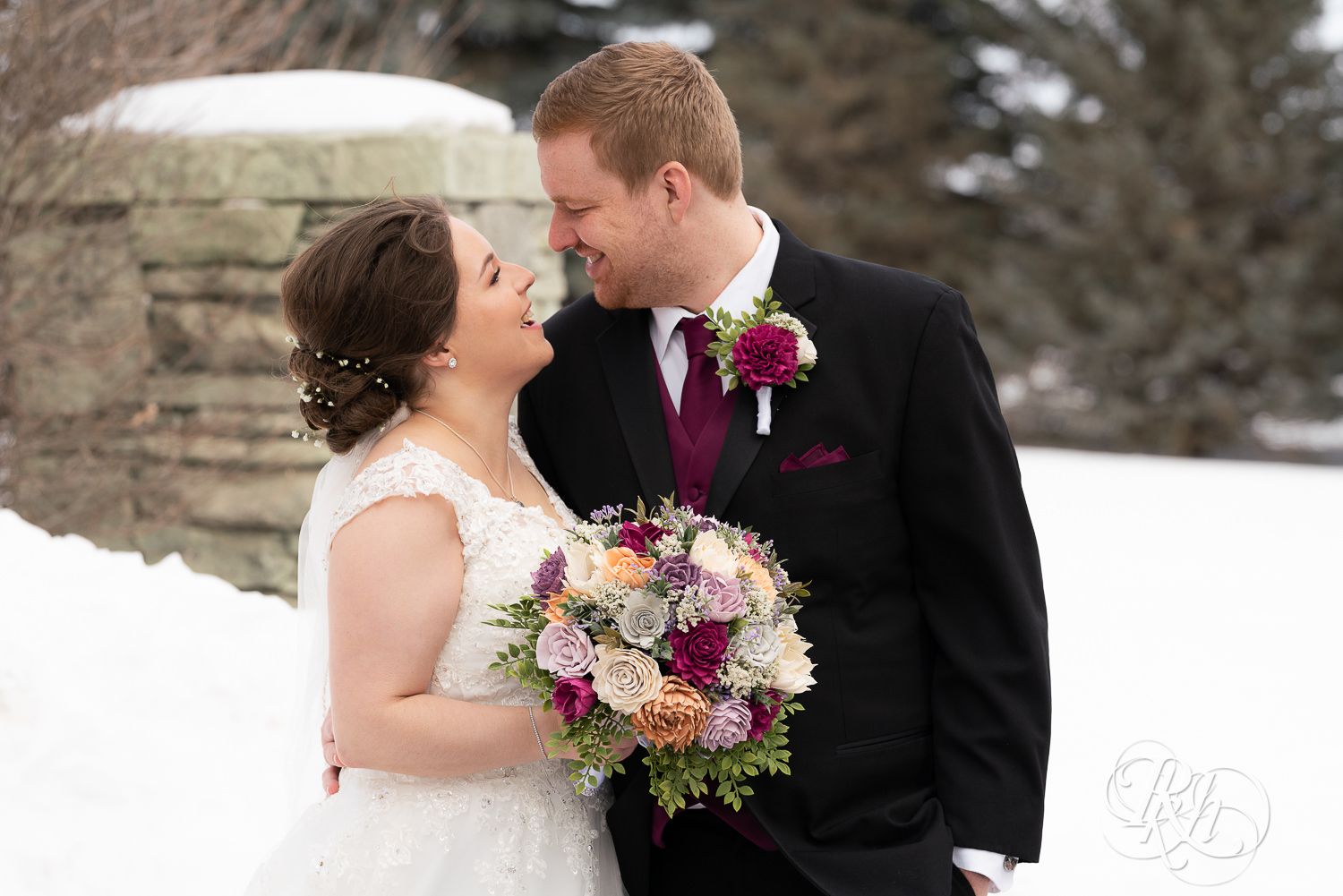 Bride and groom smiling in the snow at Glenhaven Events in Farmington, Minnesota.