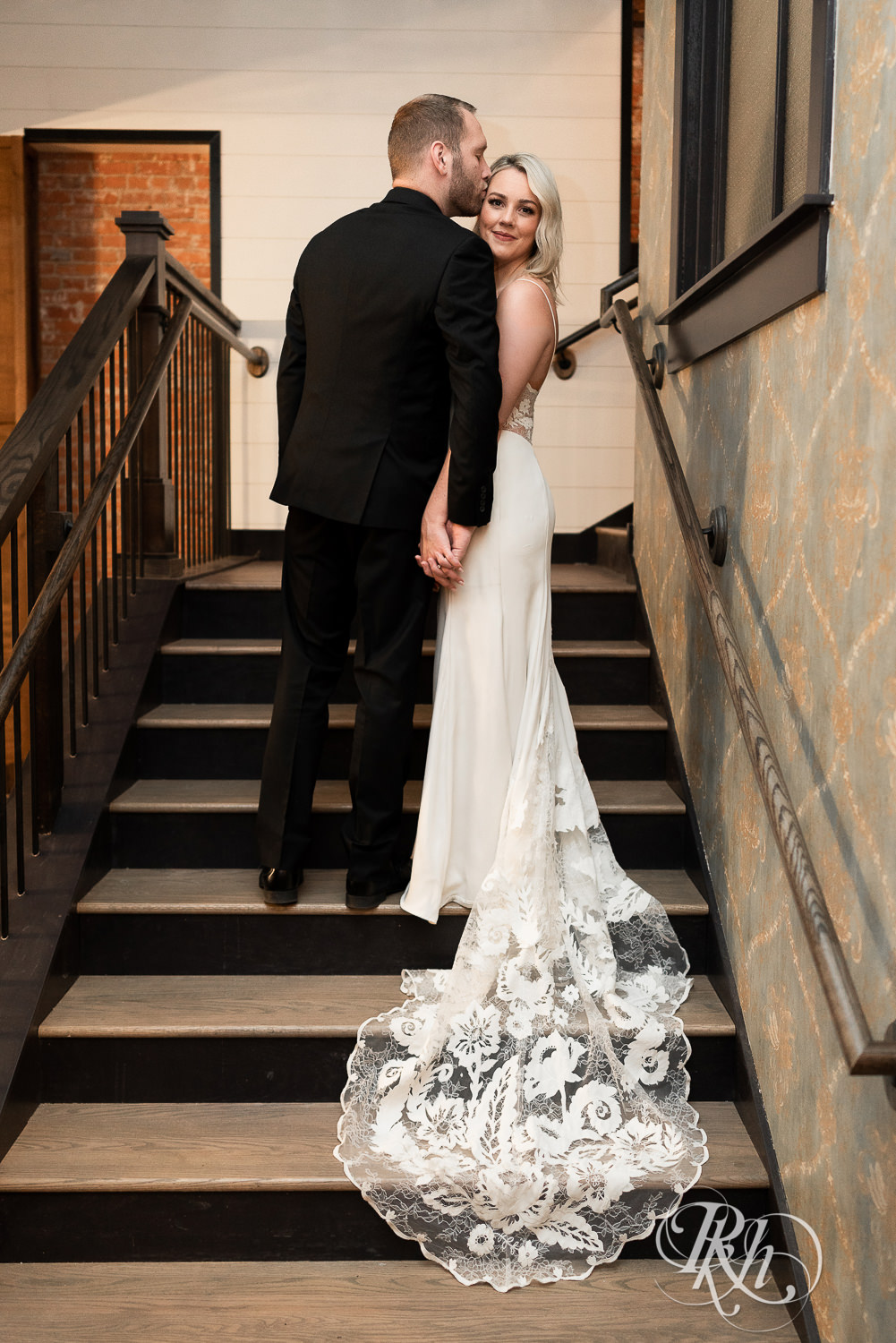 Bride and groom kissing on stairs at 3 Ten Event Venue in Faribault, Minnesota.