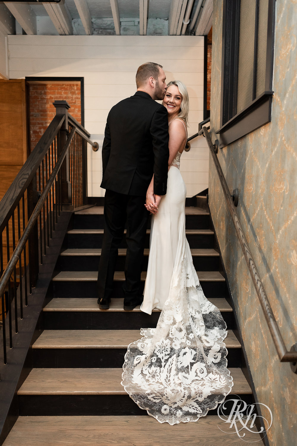 Bride and groom kissing on stairs at 3 Ten Event Venue in Faribault, Minnesota.