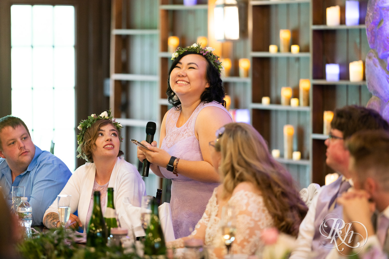 Bridesmaid laughing during reception at Hope Glen Farm in Cottage Grove, Minnesota.
