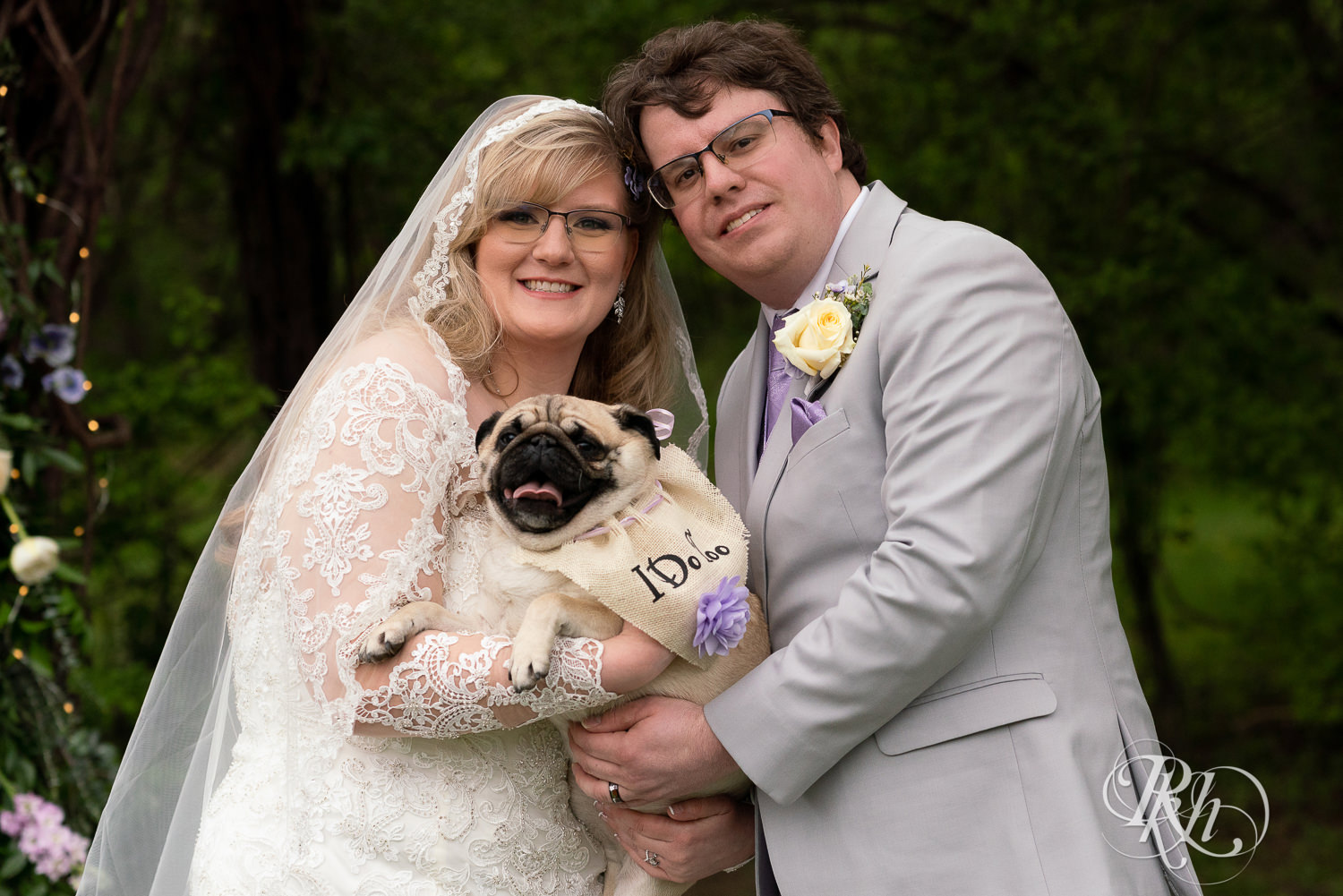 Bride and groom holding Pug at Hope Glen Farm in Cottage Grove, Minnesota.