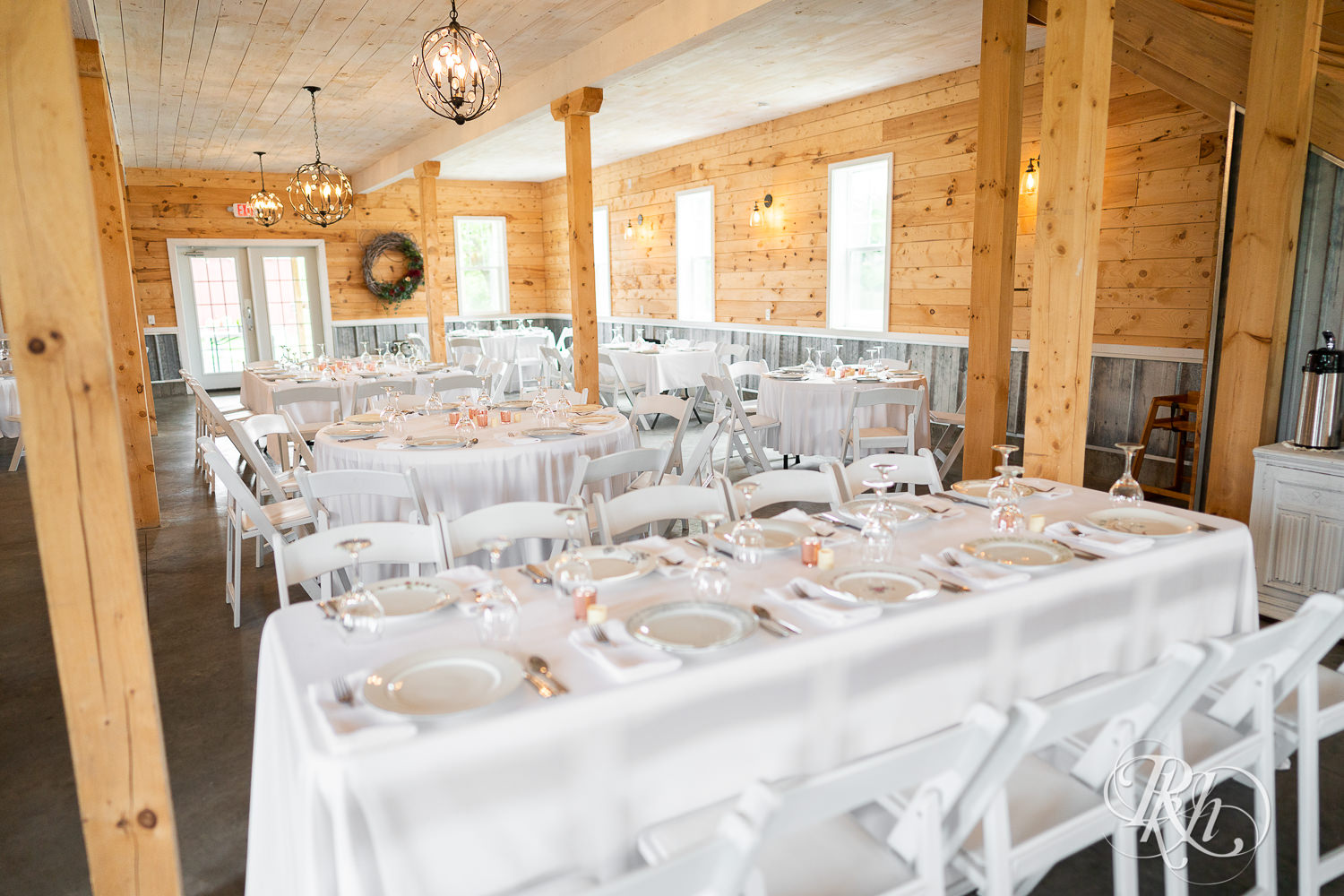 Indoor barn wedding reception setup at Barn at Mirror Lake in Mondovi, Wisconsin.