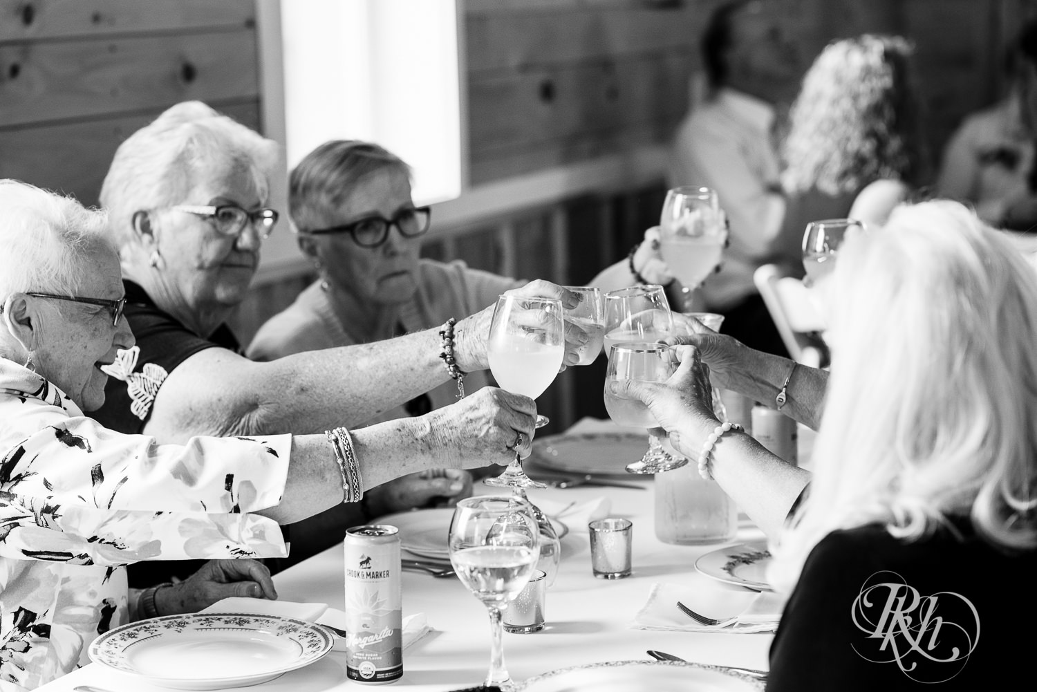 Guests toast during cocktail hour at Barn at Mirror Lake in Mondovi, Wisconsin.