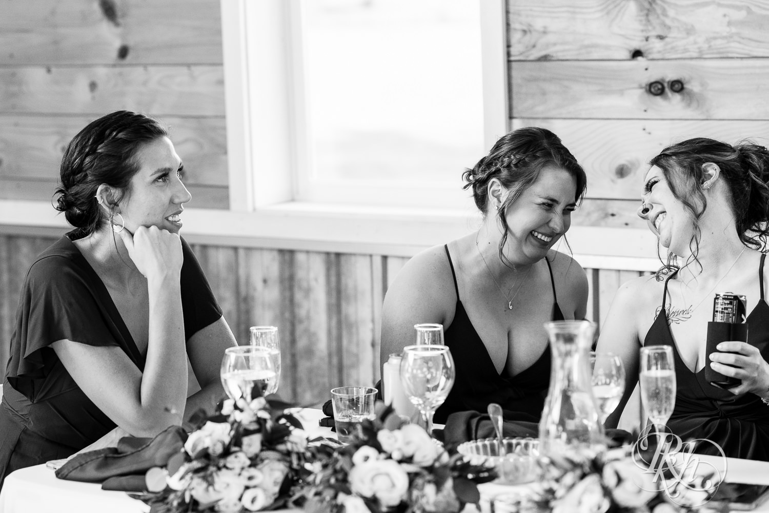 Bridesmaids laughing during reception at Barn at Mirror Lake in Mondovi, Wisconsin.