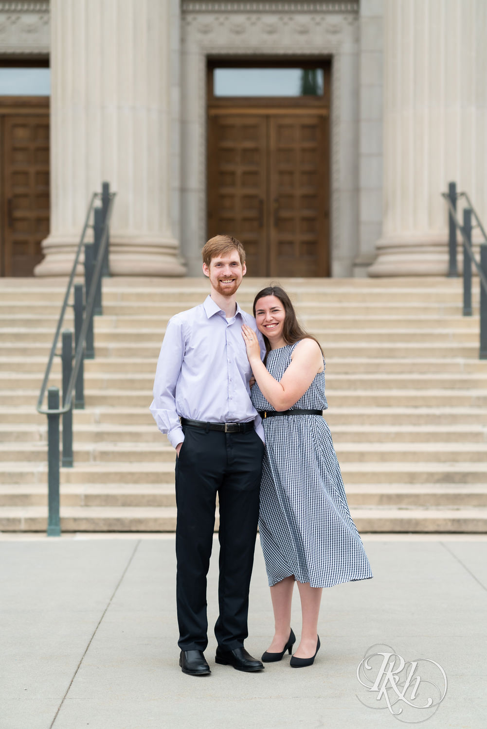Man and woman looking at camera during engagement session at University of Minnesota.