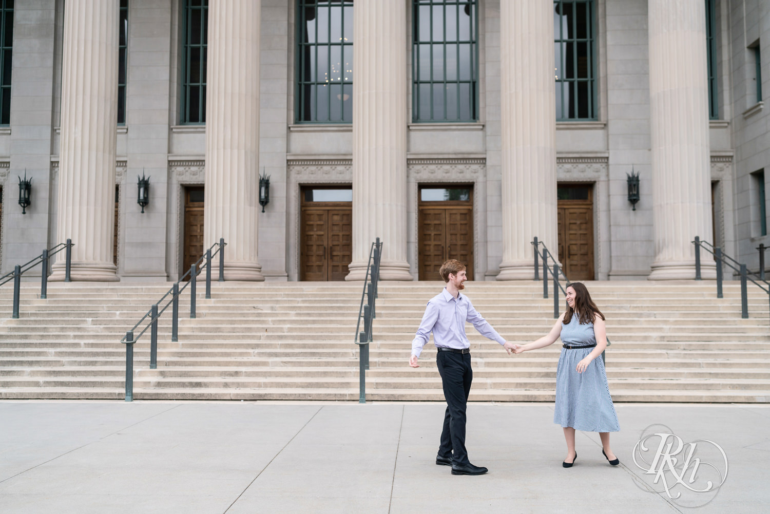 Man and woman dancing during engagement session at University of Minnesota.