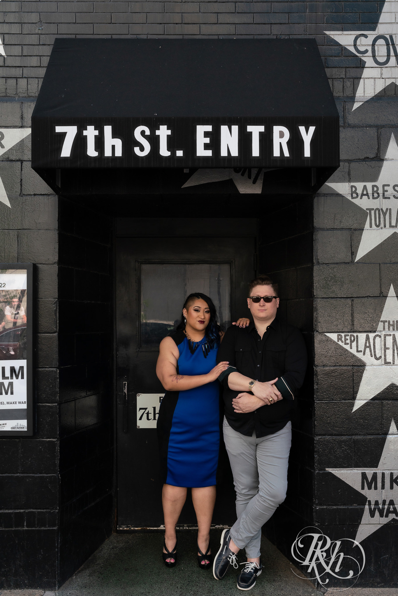Man and Filipino woman standing in front of First Avenue in Minneapolis for engagement session.