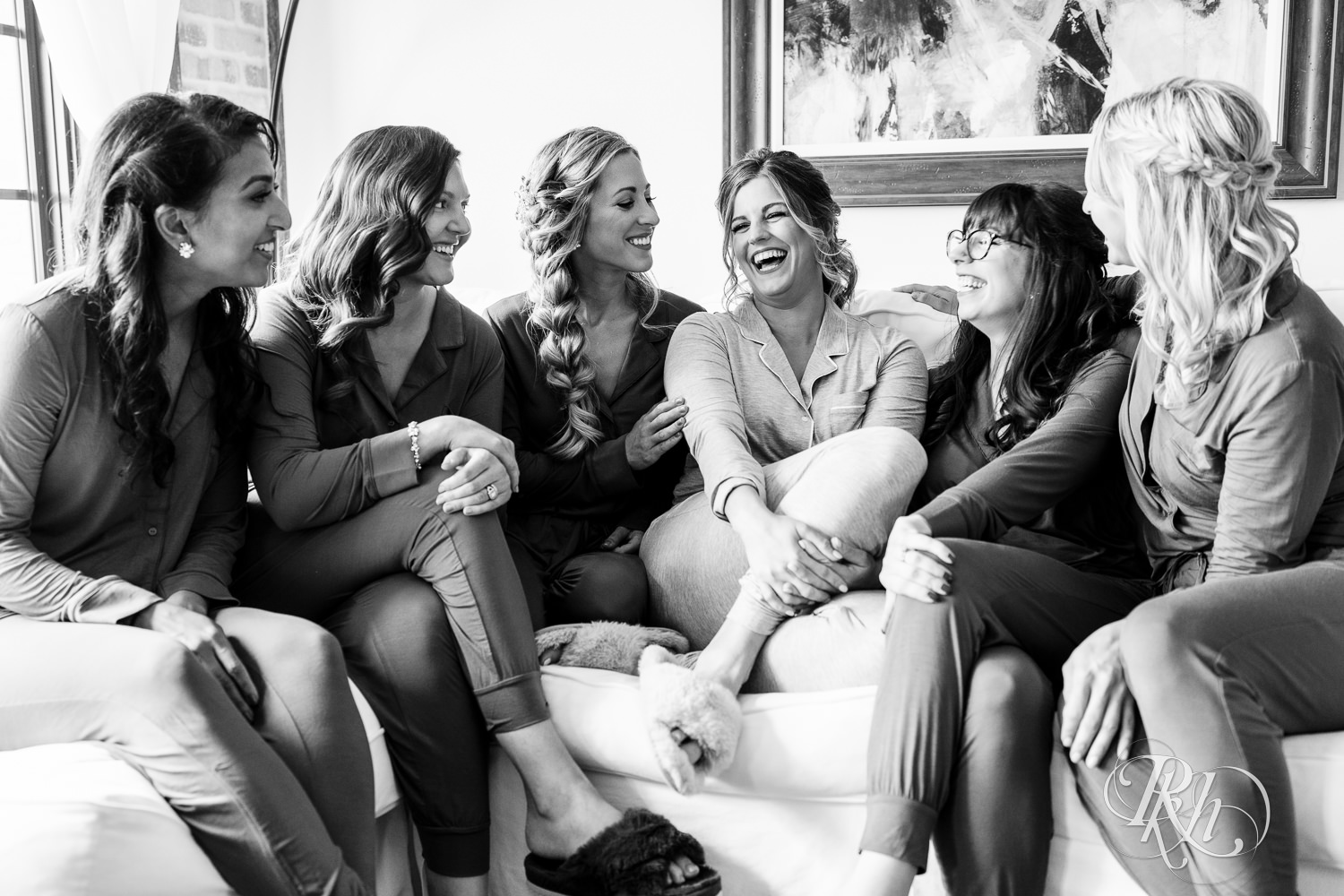 Bride and bridesmaids laughing at Hotel Crosby in Stillwater, Minnesota.