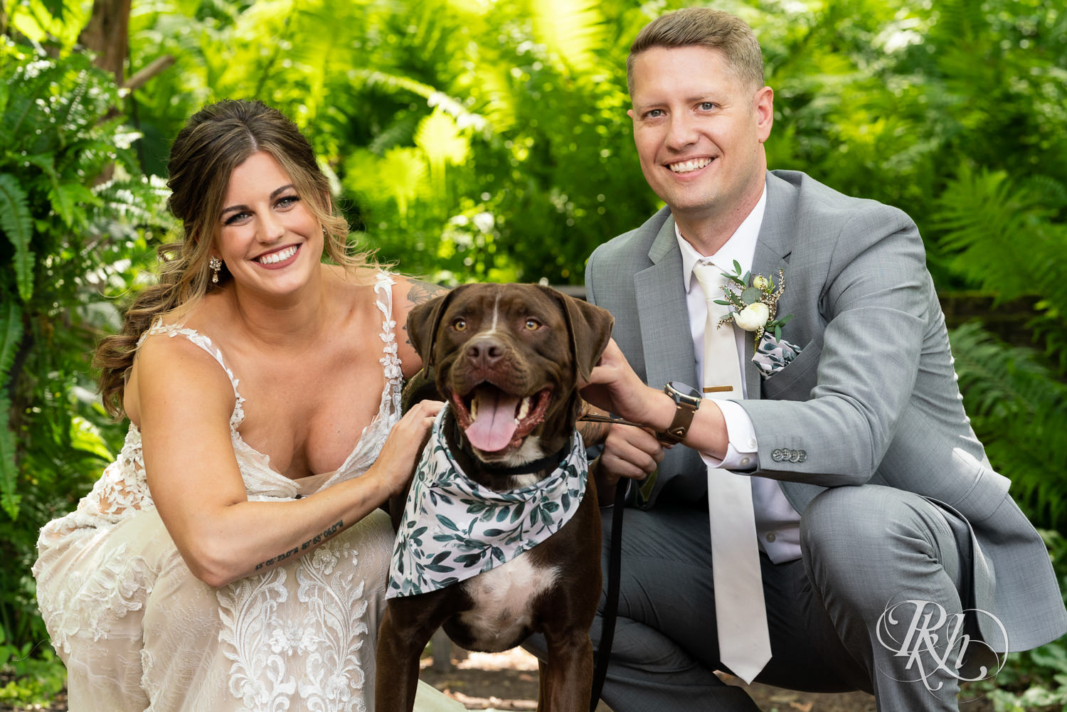 Bride and groom with their dog at Camrose Hill Flower Farm in Stillwater, Minnesota.