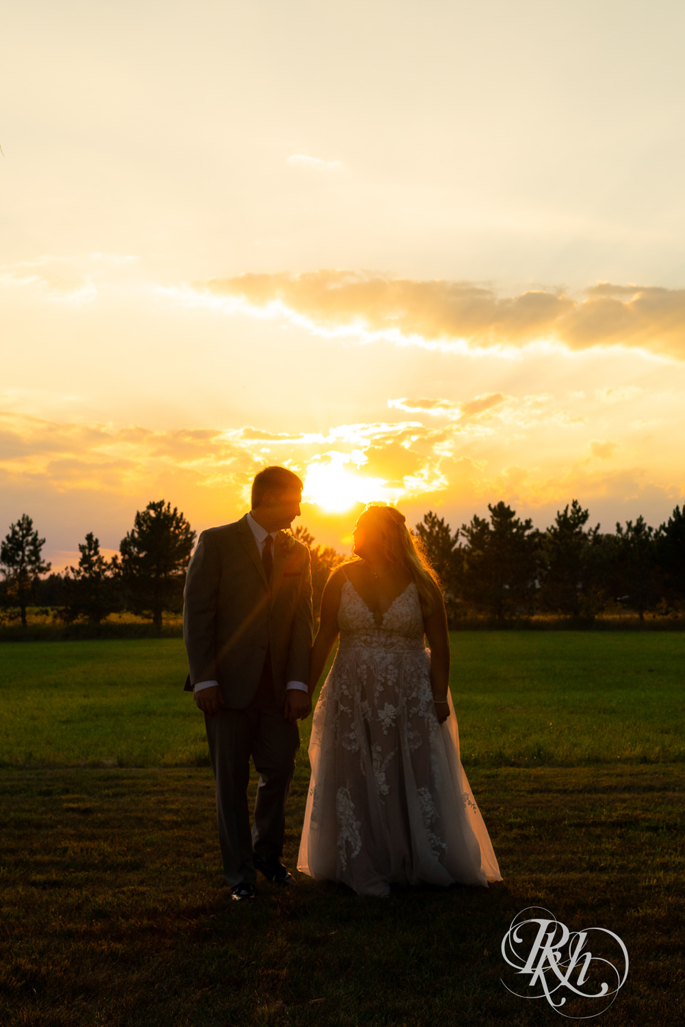 Bride and groom walking during sunset