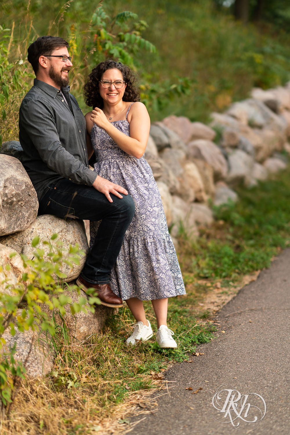 Man and woman in glasses laughing at sunset engagement session in Eagan, Minnesota.