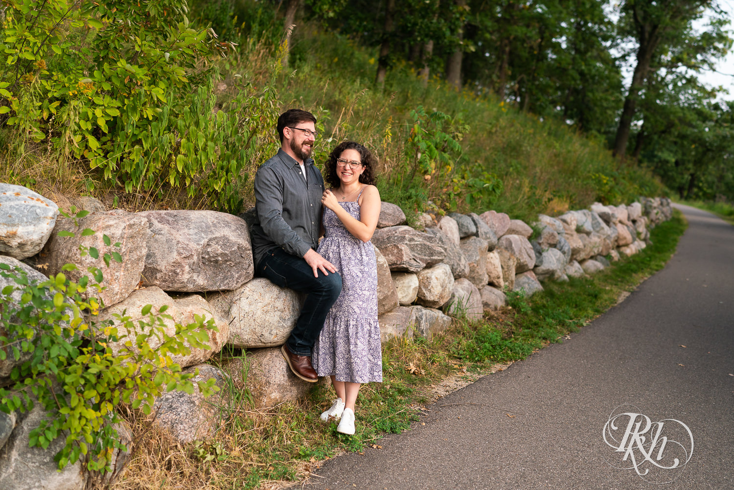 Man and woman in glasses laughing at sunset engagement session in Eagan, Minnesota.