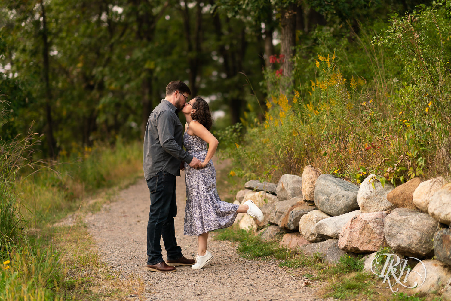 Man and woman in glasses kissing at sunset engagement session in Eagan, Minnesota.