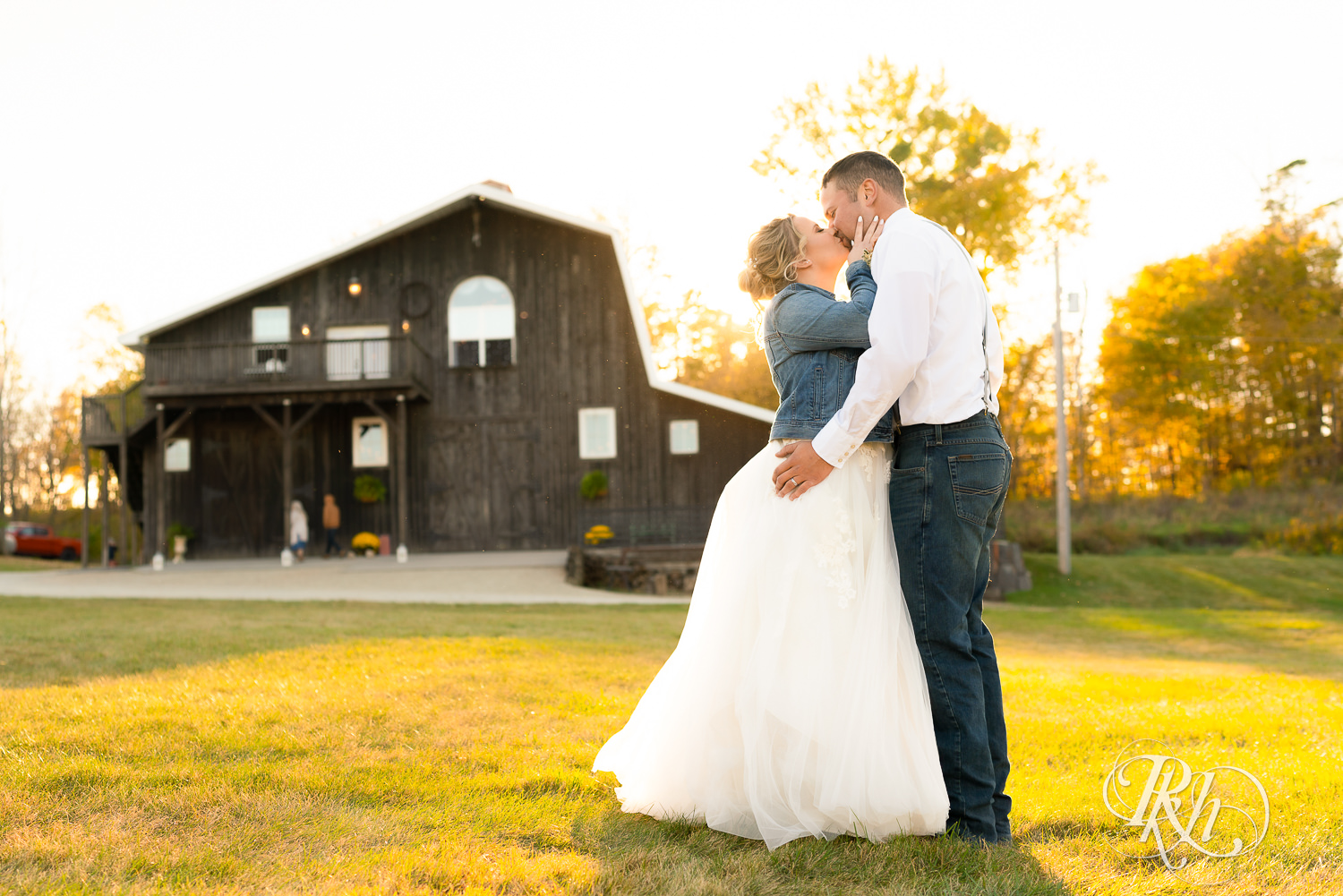 Husband and wife kiss at sunset at Barn at Crocker's Creek in Faribault, Minnesota.