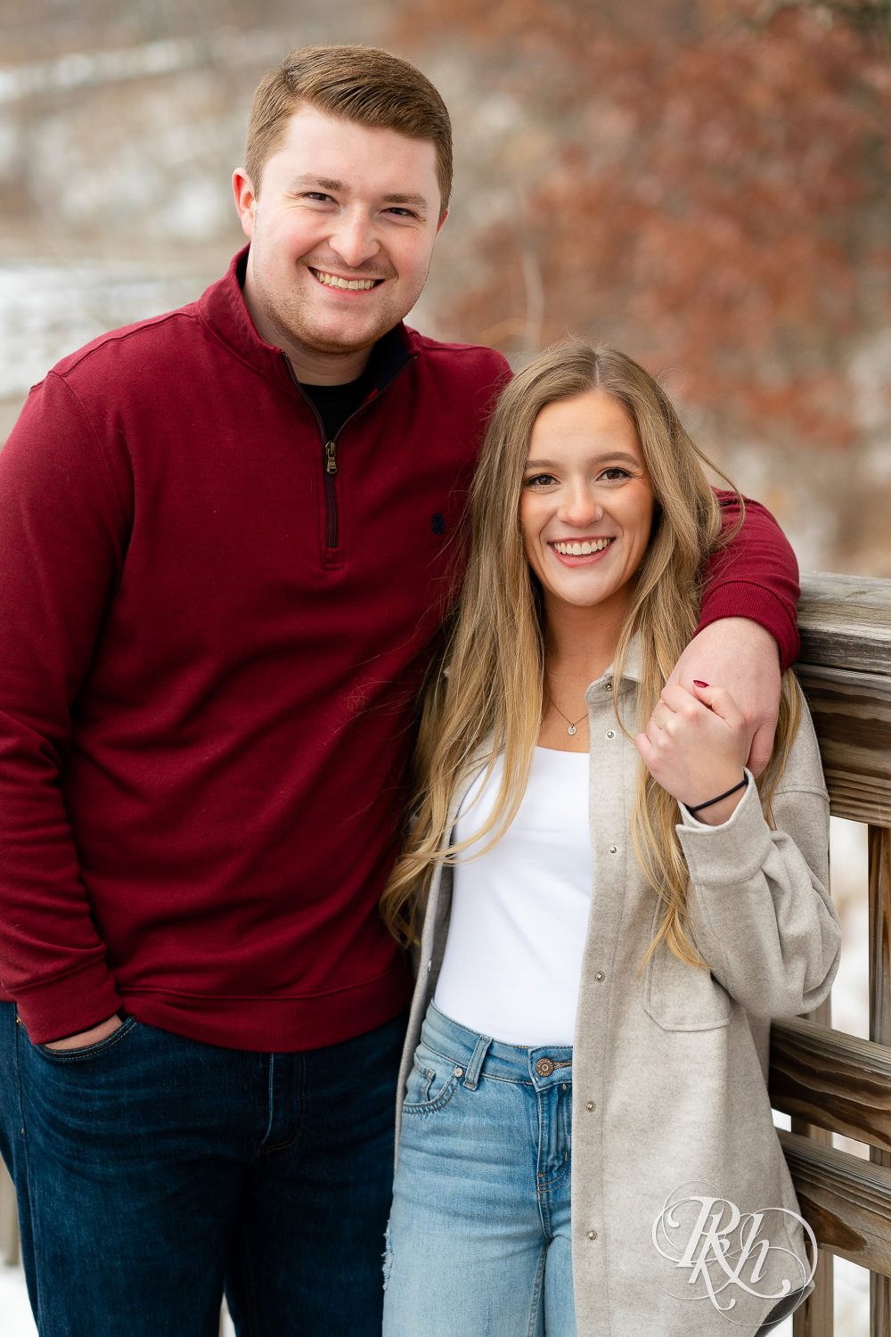 Couple smiles looking at camera in winter engagement photography
