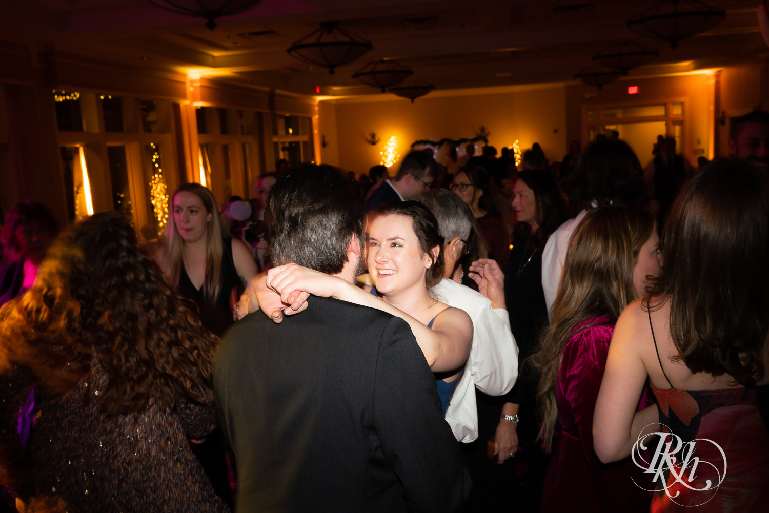 Guests dance at wedding reception at Minneapolis Golf Club in Saint Louis Park, Minnesota.