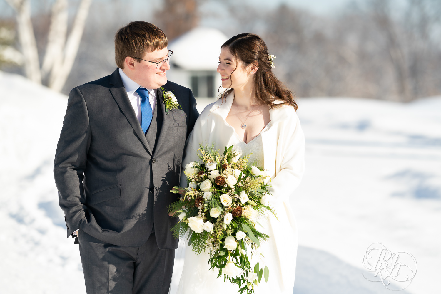 Bride and groom walking in snow outside at Minneapolis Golf Club in Saint Louis Park, Minnesota.