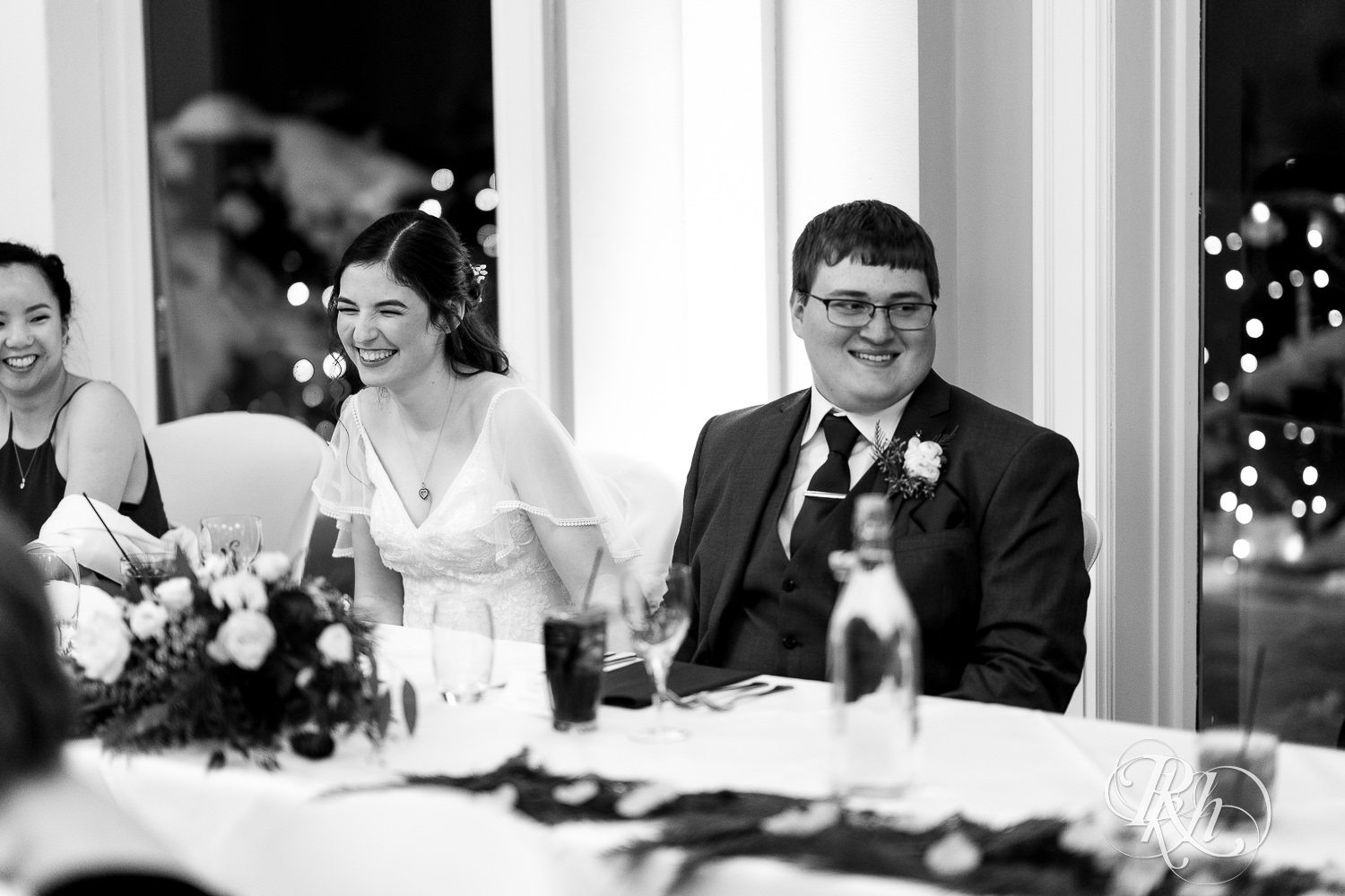 Bride and groom laugh at wedding reception at Minneapolis Golf Club in Saint Louis Park, Minnesota.