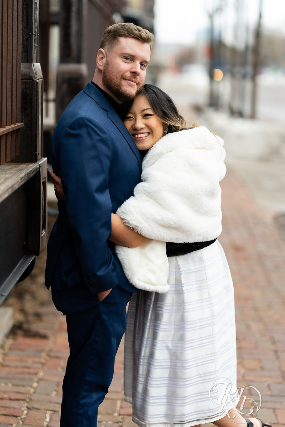 Man and Hmong woman snuggle in Saint Anthony Main in Minneapolis, Minnesota.