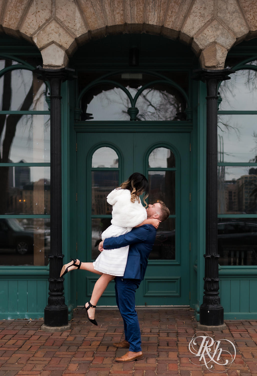 Man lifts Hmong woman in Saint Anthony Main in Minneapolis, Minnesota.