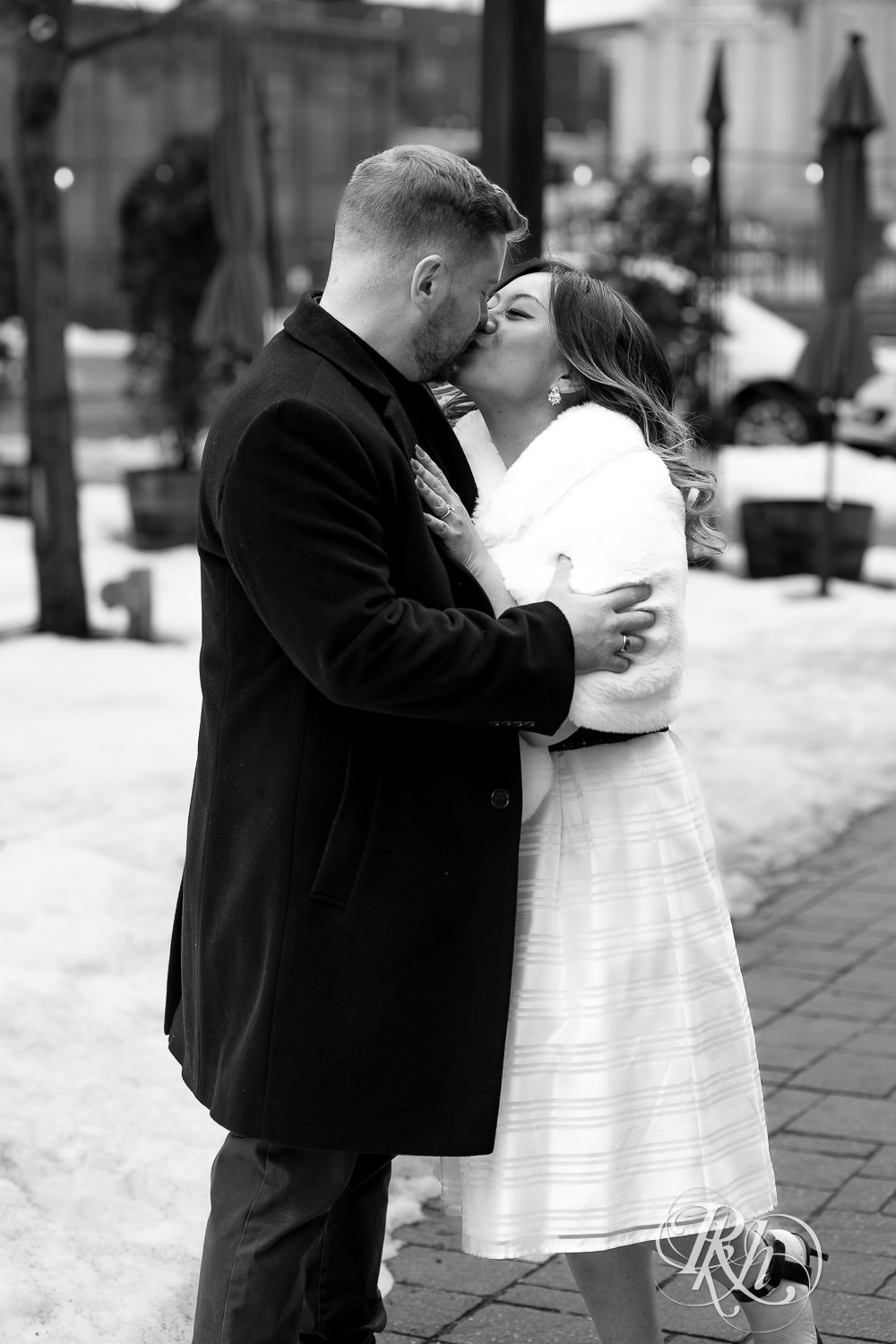 Man and Hmong woman kiss in Saint Anthony Main in Minneapolis, Minnesota.