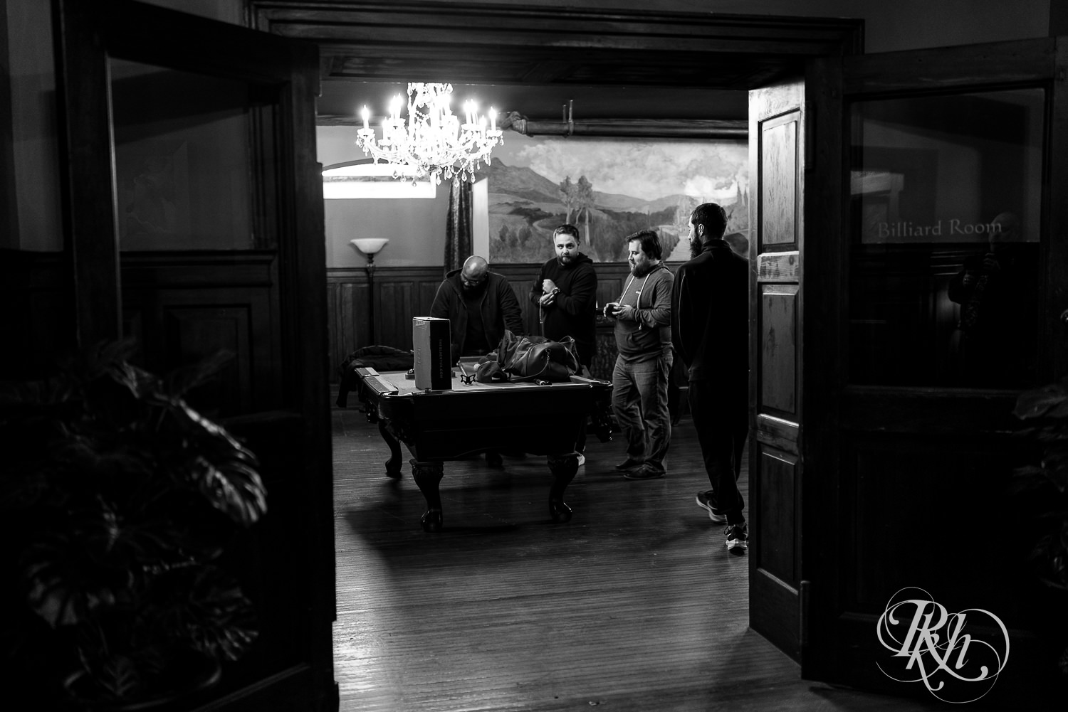 Groom and groomsmen standing by pool table at Semple Mansion in Minneapolis, Minnesota.