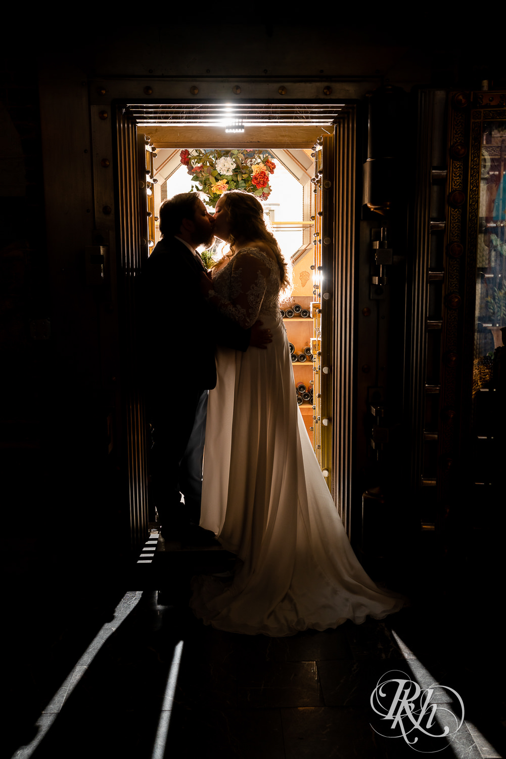 Bride and groom kissing in wine grotto at Semple Mansion in Minneapolis, Minnesota.
