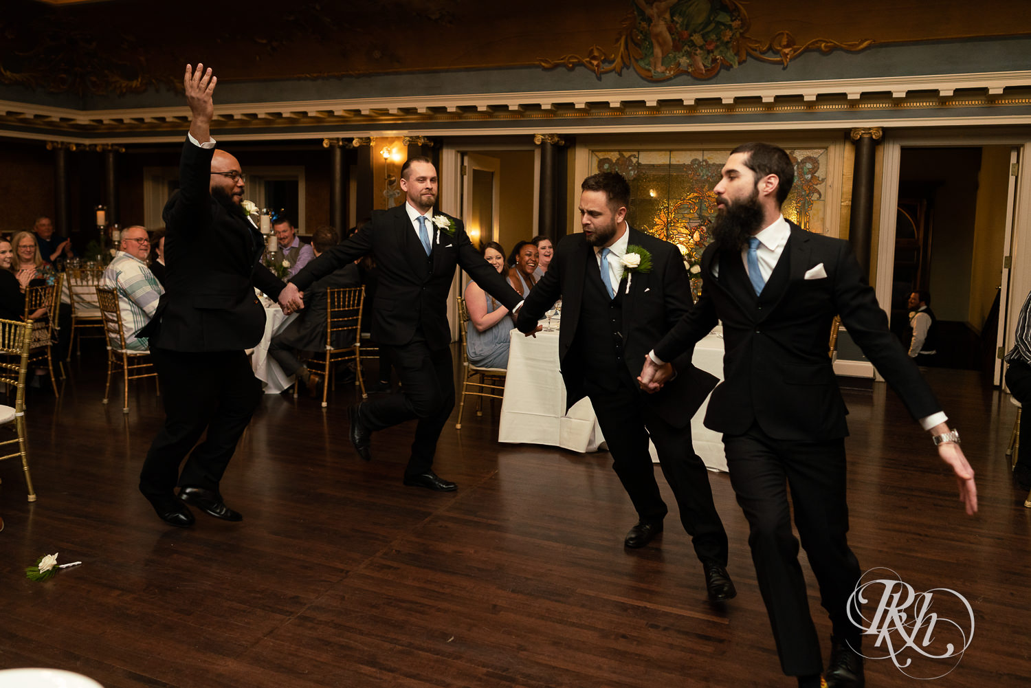 Groomsmen dance during grand entrance at Semple Mansion in Minneapolis, Minnesota.