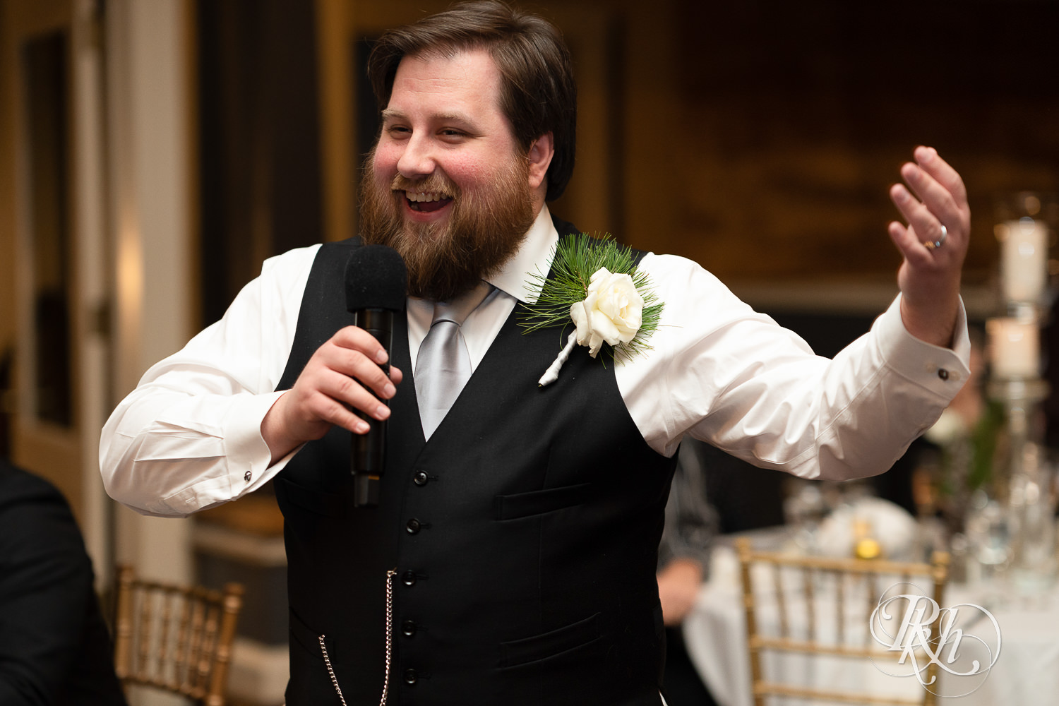 Groom smiles during speech at Semple Mansion in Minneapolis, Minnesota.