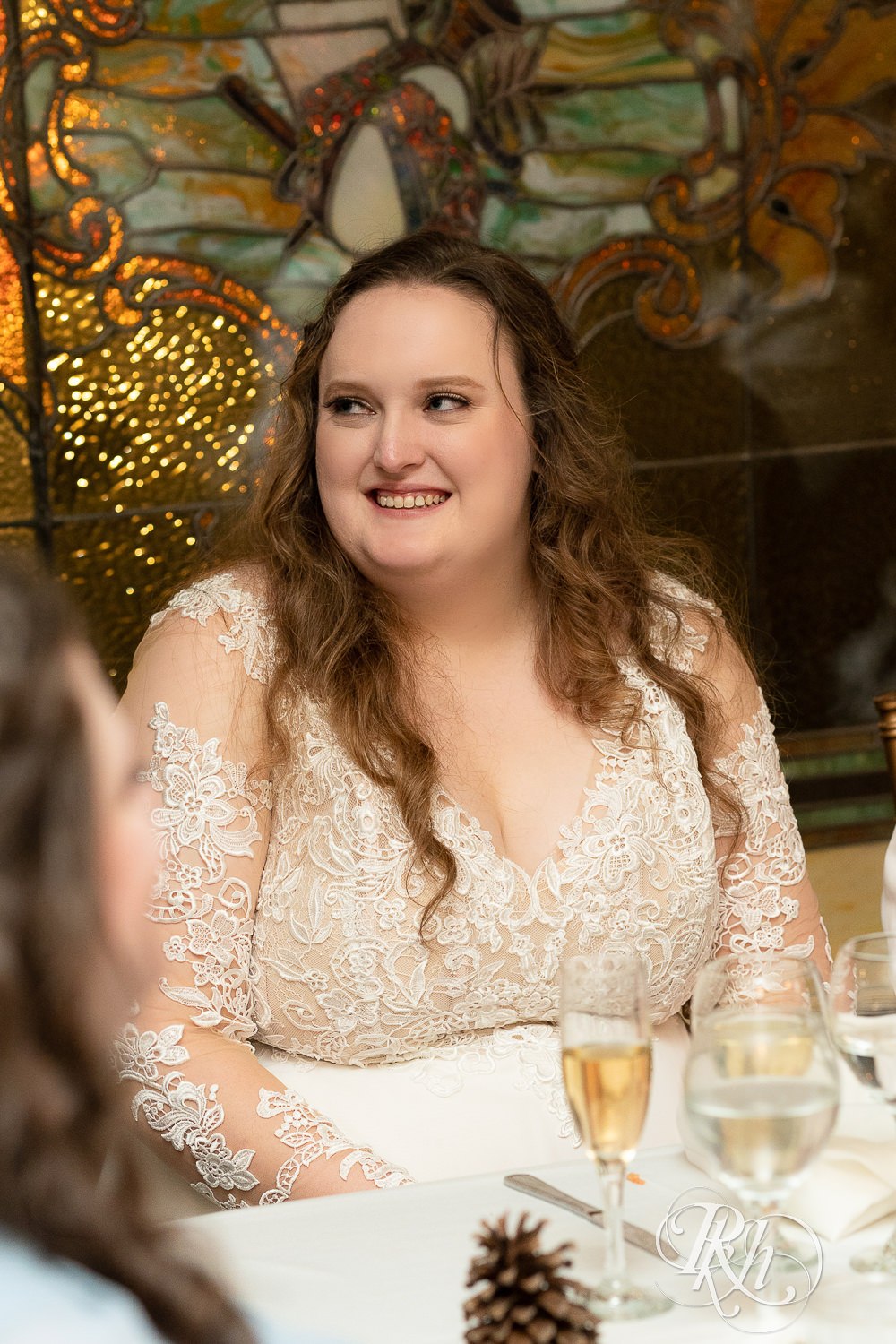 Bride laughs during speeches at Semple Mansion in Minneapolis, Minnesota.