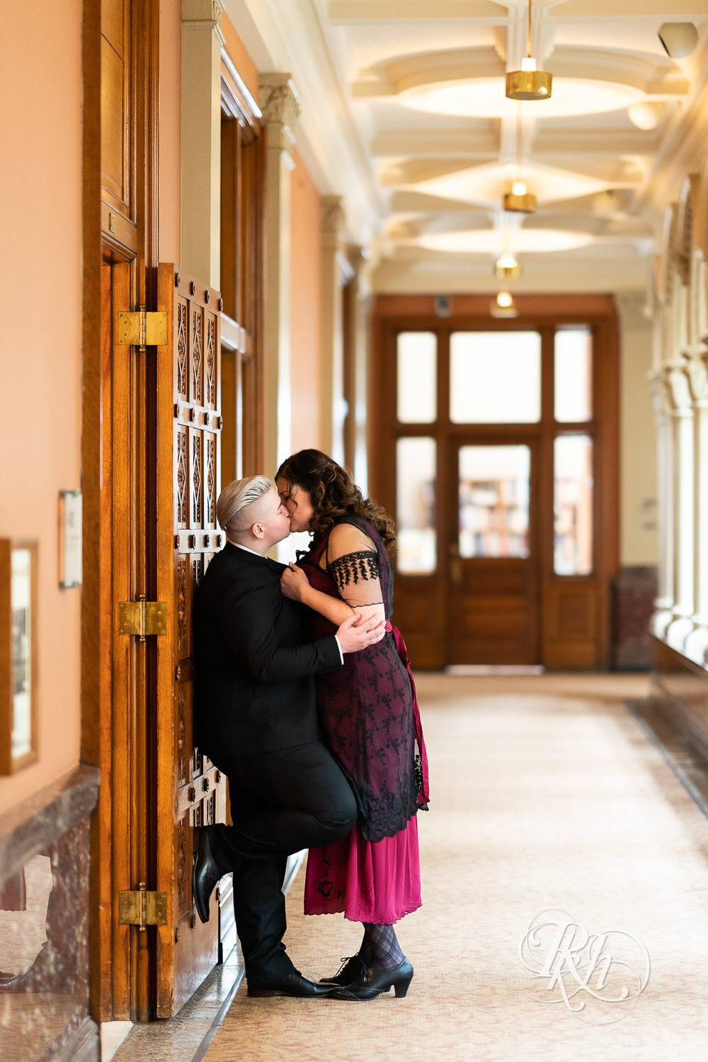 Lesbians kiss dressed in Titanic dress and suit in Landmark Center in Saint Paul, Minnesota.