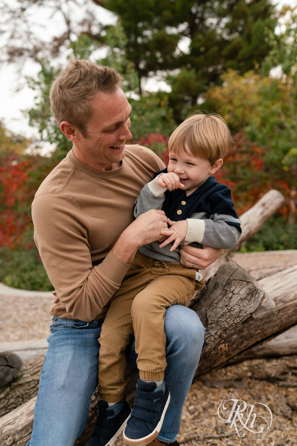 Minnesota outdoor family photography of little boy laughing with dad at Whitetail Woods in Farmington, Minnesota.